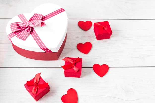 Free photo hearts and gift boxes on wooden tabletop