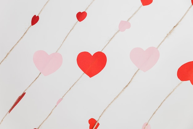 Free photo hearts laid on ropes on a white background
