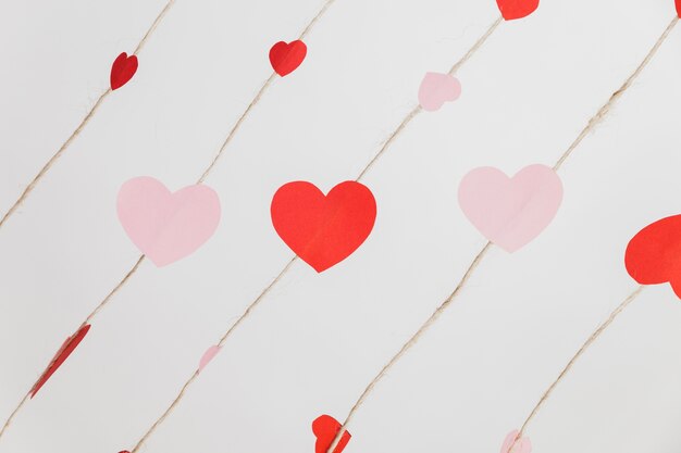 Hearts laid on ropes on a white background