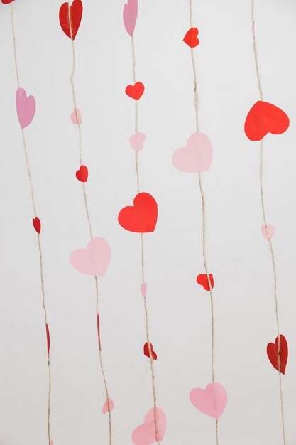 Hearts laid on ropes on a white background