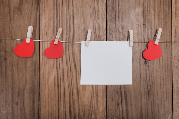 Hearts and a paper hanging on a rope