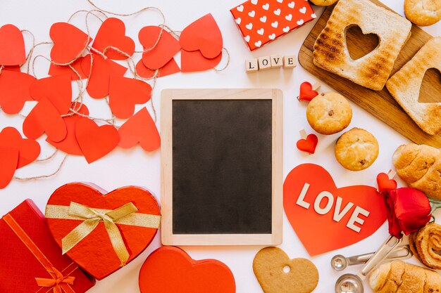 Hearts and pastry around chalkboard