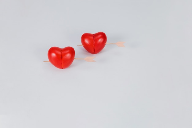 Free photo hearts punctured by a stick