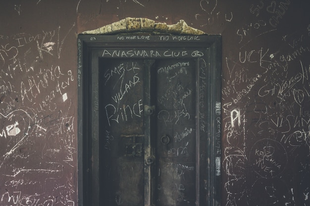 Free photo heavily vandalized vintage door