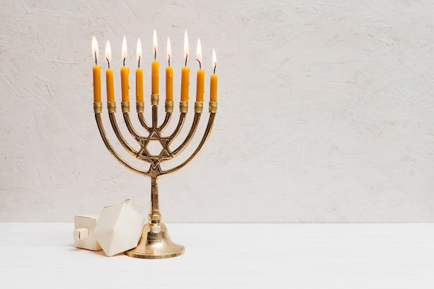 Hebrew menorah with candles burning