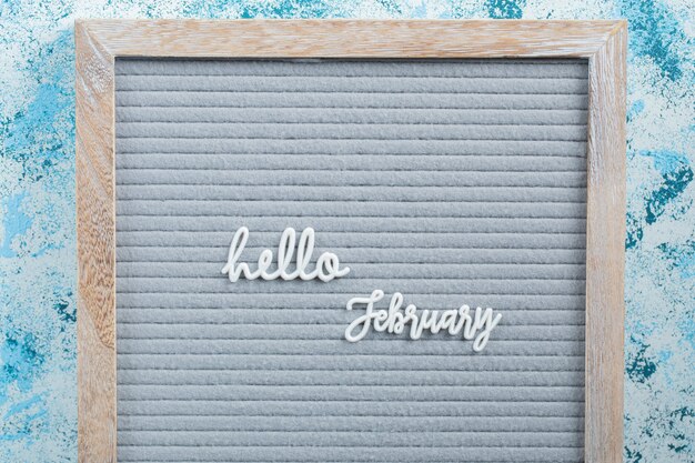 Hello february poster on blue surface