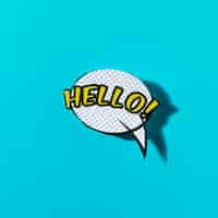 Free photo hello lettering text in a speech bubble on turquoise backdrop