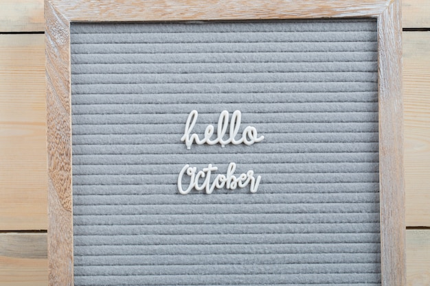 Free photo hello october poster on brown surface