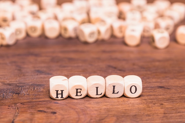 Free photo hello word made with dices on wooden desk