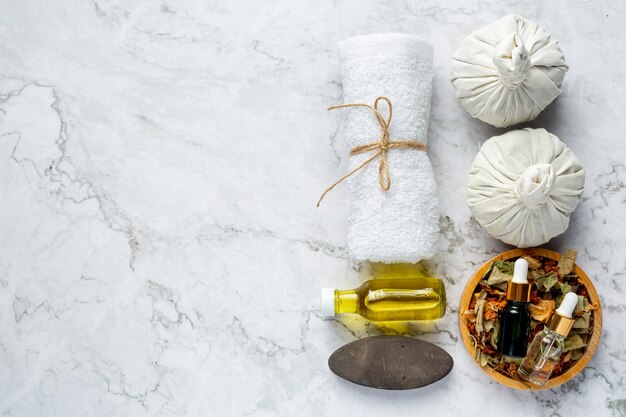 Herbal spa treatment equipments put on white marble floor