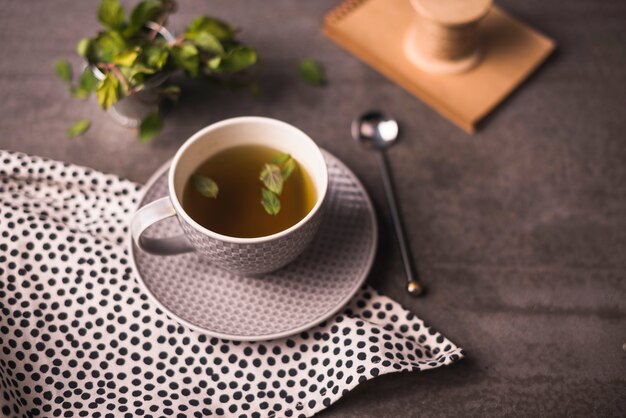 Herbal tea and polka dotted cloth on table