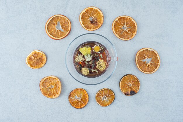 Herbal tea with dried orange on gray background. High quality photo