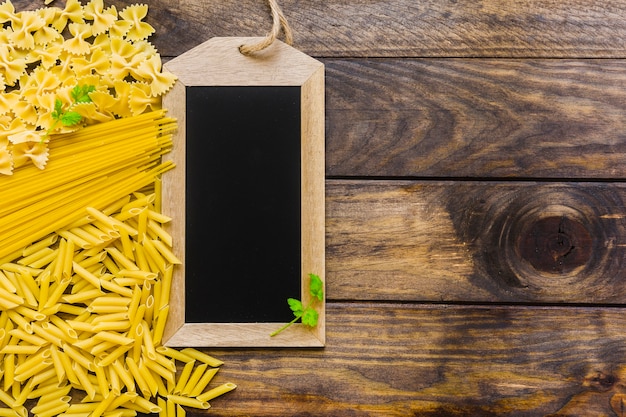 Herbs on chalkboard and pasta