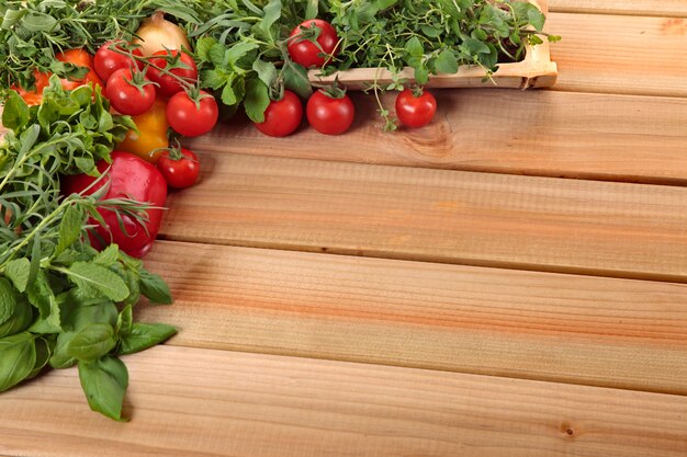 Herbs and vegetables with a wooden board