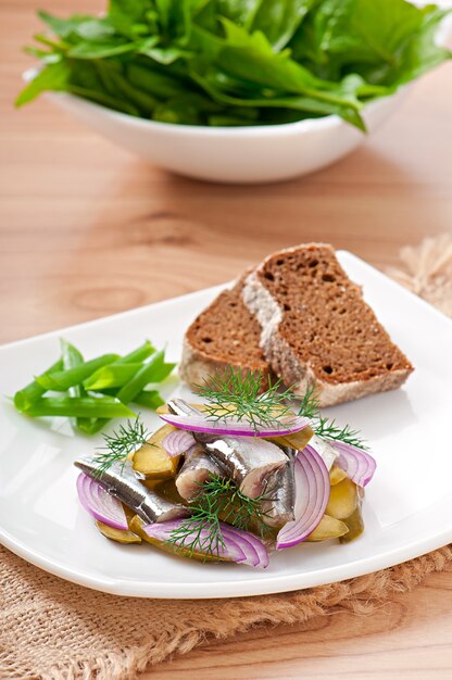 Herring salad with pickled cucumbers and onions