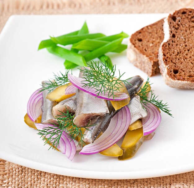 Herring salad with pickled cucumbers and onions