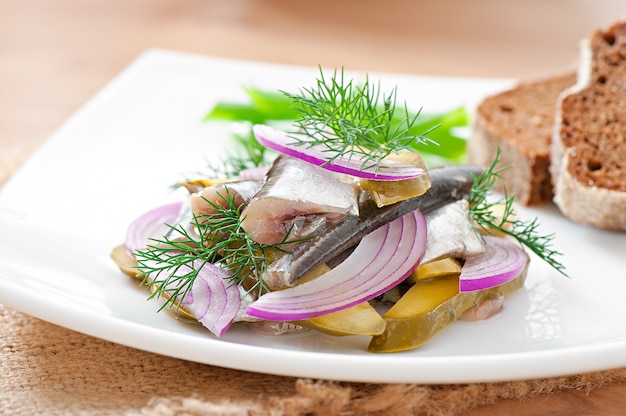 Herring salad with pickled cucumbers and onions