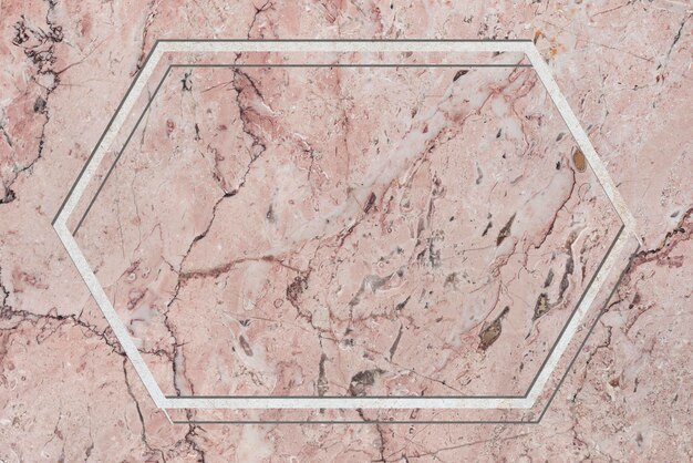 Hexagon frame on pink marble textured background