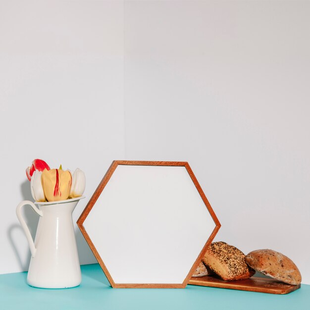 Hexagon frame between tulips and pastry