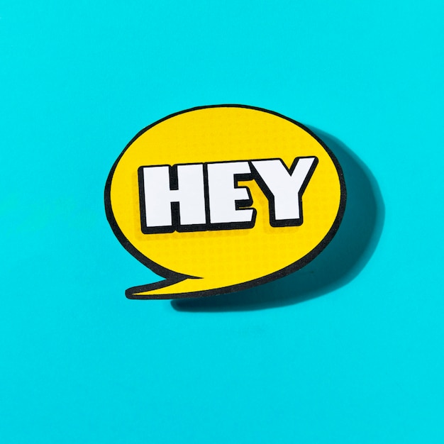 Hey text on yellow speech bubble on blue background