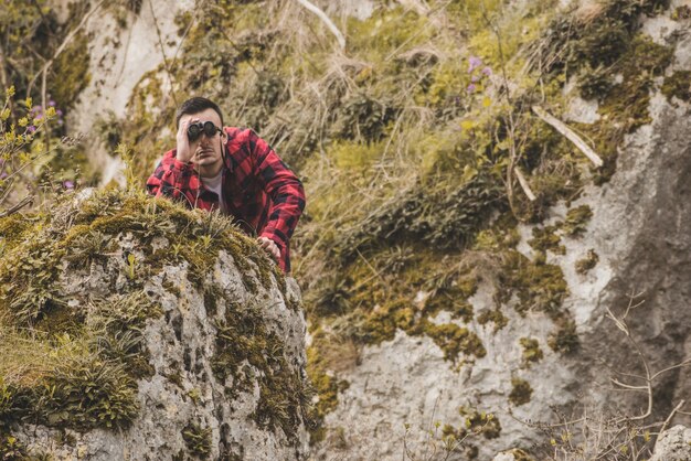 Hidden hiker using binoculars