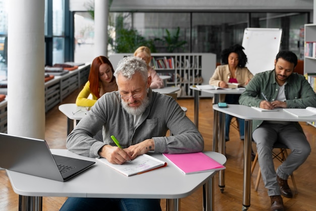 Free photo high angle adults studying together