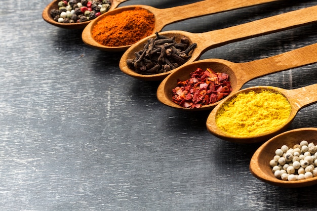 High angle aligned spoons with spices powder