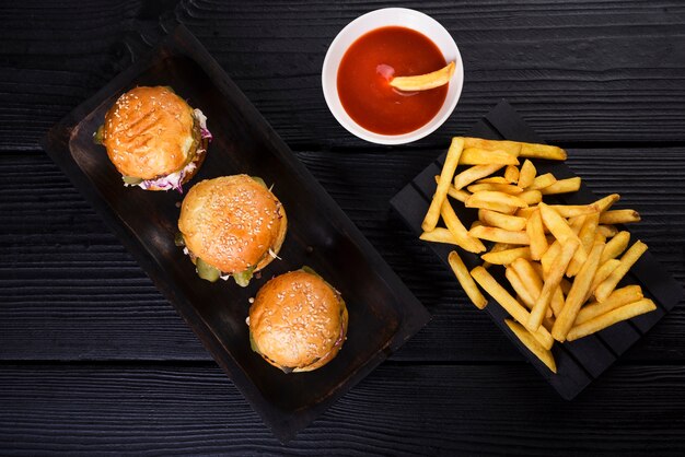 High angle american burgers with fries and sauce