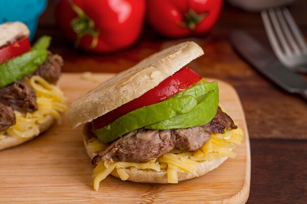 High angle of arepas with avocado and meat