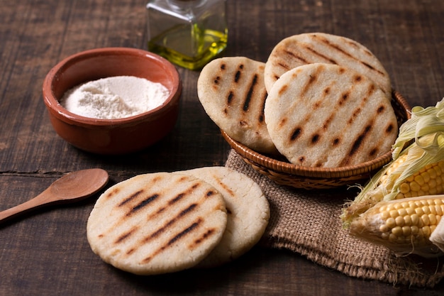 High angle arepas with flour bowl