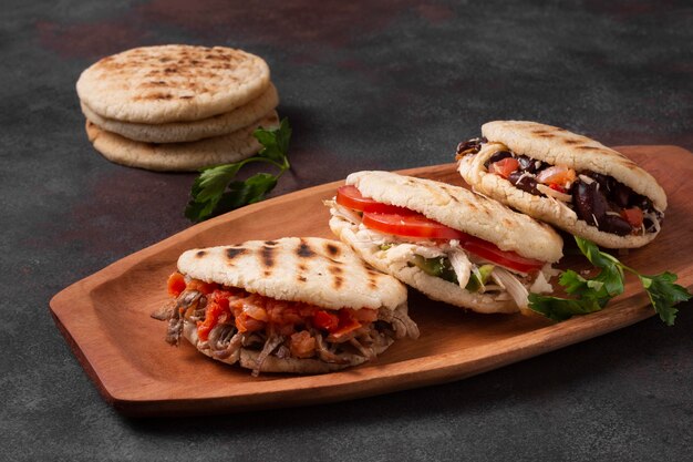 High angle arepas on wooden tray