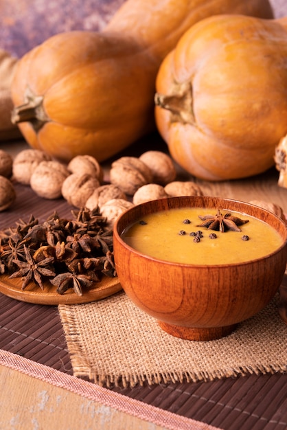 Free photo high angle arrangement with pumpkin soup and nuts