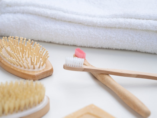 Free photo high angle arrangement with tooth brushes and towels