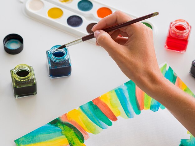 High angle of artist painting with watercolor