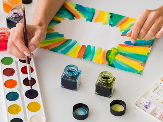 High angle of artist painting with watercolor