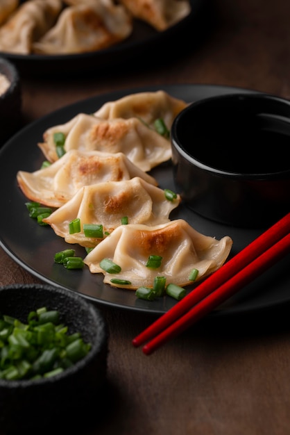 High angle of asian dish on plate with herbs and chopsticks