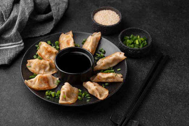 High angle of asian dumplings dish with herbs