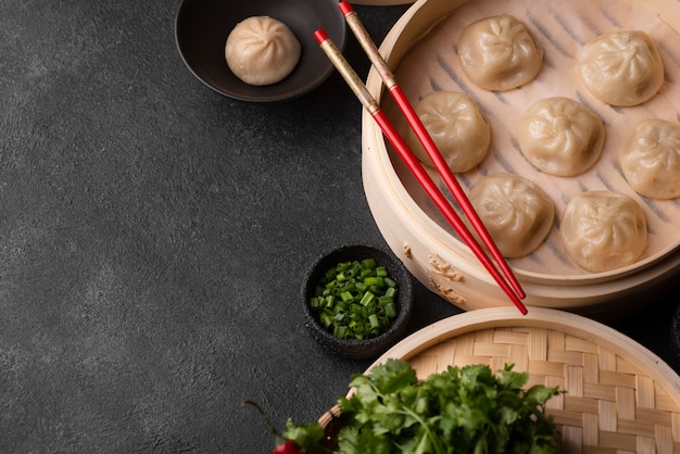 High angle of asian dumplings with chopsticks and copy space