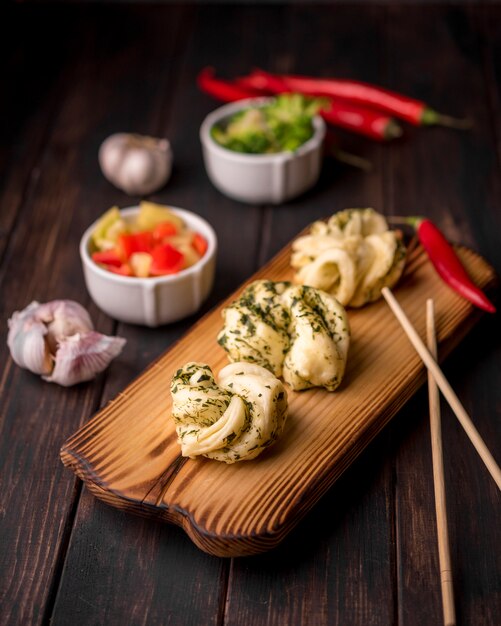 High angle of asian food on wooden board with garlic