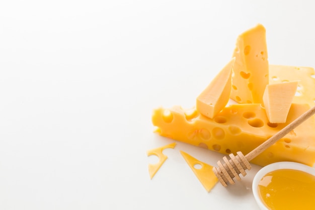High angle assortment of cheese and honey with copy space