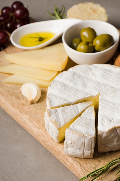 High angle assortment of different delicacies on wooden board