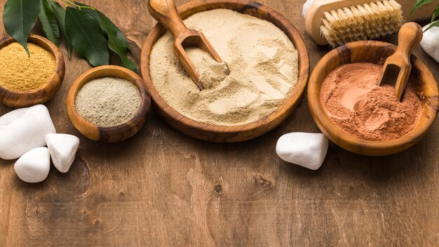 High angle of assortment of fine powders in bowls with stones