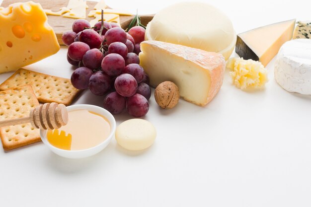 High angle assortment of gourmet cheese and grapes