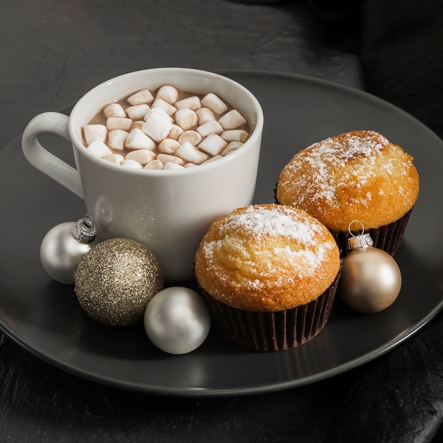 Free photo high angle assortment with marshmallow drink and muffins