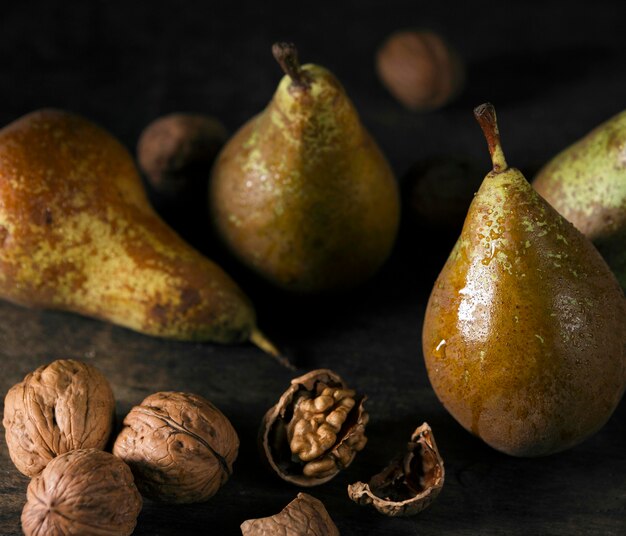 High angle of autumn pears with walnuts