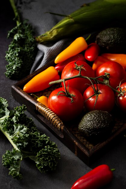 High angle avocados, tomatoes and peppers in tray