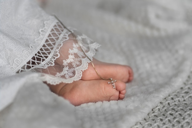 High angle baby feet with cross