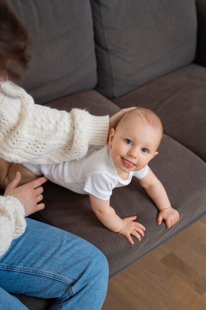 High angle baby holding tongue out