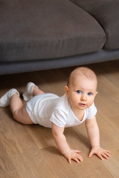 Free photo high angle baby leaning on his arms