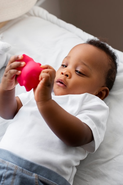 High angle baby playing with toy